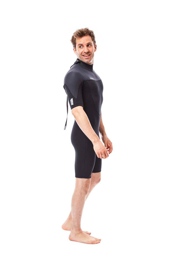 Male model wearing Jobe Perth 3mm Mens Shorty Wetsuit with a back zip entry. View of the side